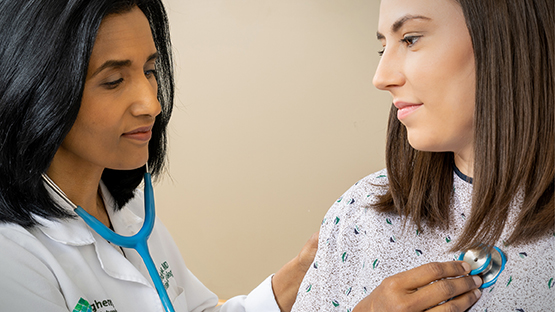 Doctor listening to patient's heartbeat with stethoscope