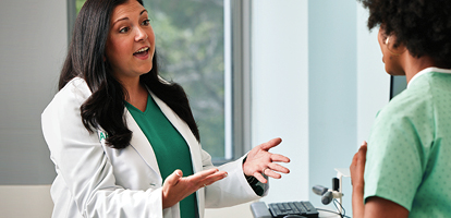 AHN OB-GYN talking to a patient during an exam