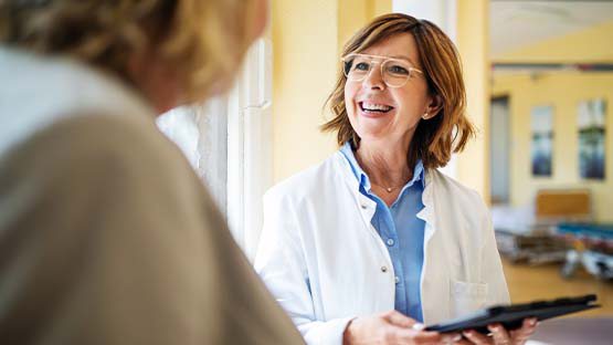 female doctor smiling and interacting with a female patient