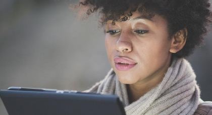 A woman using a laptop to view her MyChart and access her medical records.