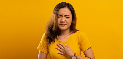 A woman experiencing heartburn.