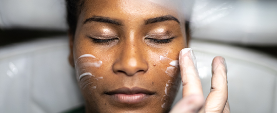 A close up shot of a person receiving facial treatment.
