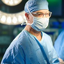 Surgeon in scrubs preparing for Kaposi Sarcoma surgery at AHN Cancer Institute
