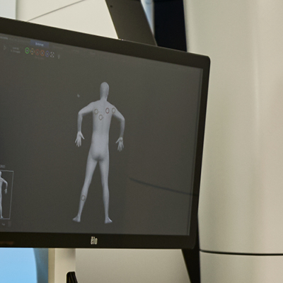 A monitor displaying a 3D model of a human body.