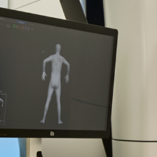 A monitor displaying a 3D model of a human body.