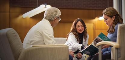 A care team reviews patient files to better understand a diagnosis for squamous cell skin cancer.
