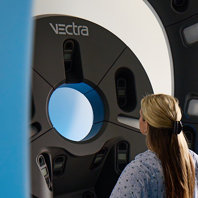 Patient undergoing a VECTRA 3D imaging scan for targeted radiation therapy planning for squamous cell skin cancer.