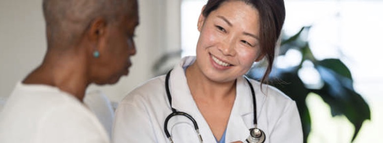 A patient and doctor smiling and talking together