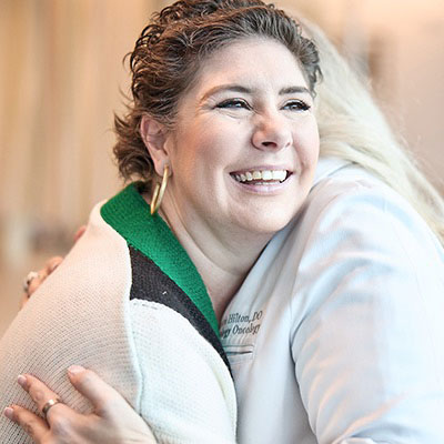 AHN cancer specialist giving a patient a hug.