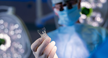 An AHN cardiovascular surgeon holding a TAVR