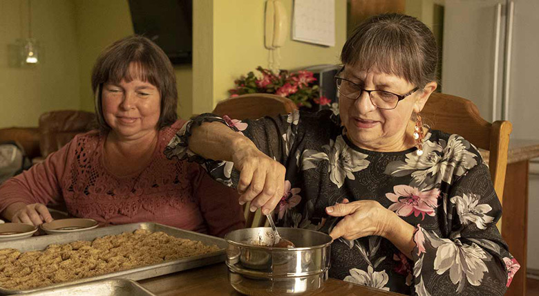 AHN cardiac patient portioning out cookie dough with a family member at her kitchen table