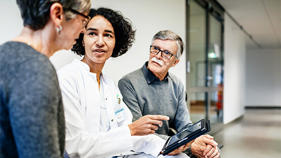 Patients receive expert consultation from a doctor reviewing their autoimmunity care plan on a tablet