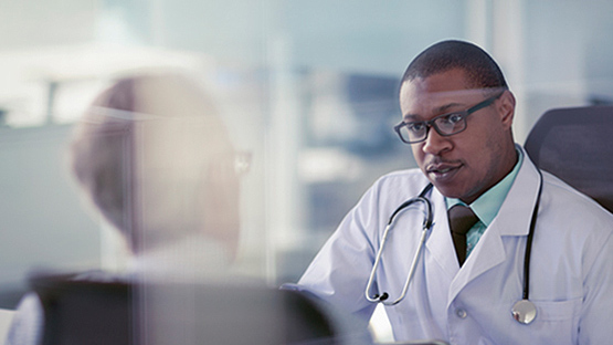 An AHN doctor consulting with a patient in an office about the various techniques that they provide.