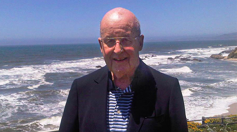 Frank Cahouet smiling in front of the ocean