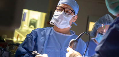 A neuroscience surgeon focusing on procedure during a surgery.