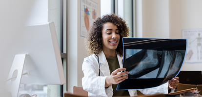 doctor holding up an x-ray of a person's foot and ankle