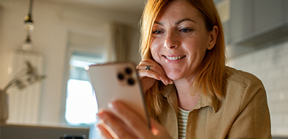 A woman using her cellphone to schedule a orthopaedic appointment.