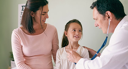 A primary care physician examining a child with her mom present.