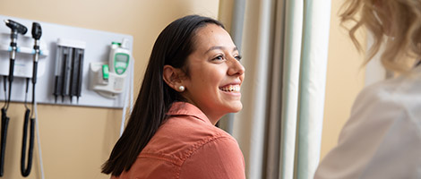 A woman smiling at her physician.