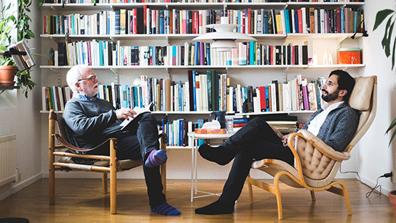 Psychiatrist talking to patient in his office.