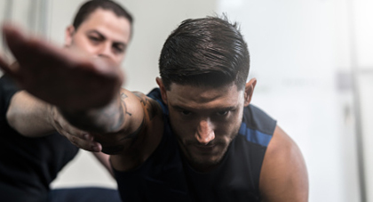 A physical therapist helping a patient with shoulder injury.