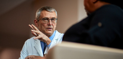 AHN doctor talking to a patient while gesturing with his hand,