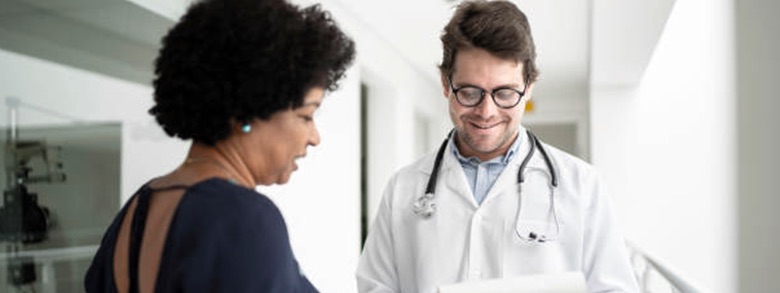 A doctor and patient smiling and talking