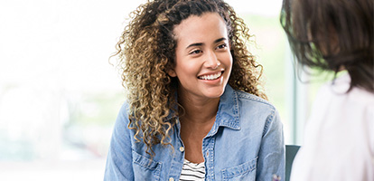 A woman facing her doctor and smiling