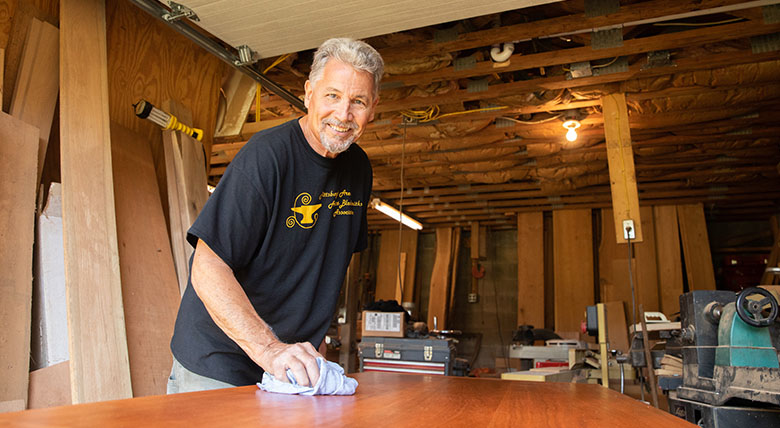 West Penn Hospital cancer survivor Gene Mazzetti working in his woodshop