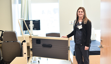 physical therapist posing for a photo in a physical therapy room