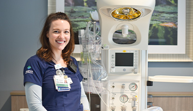 women posing for a picture in front of medical equipment