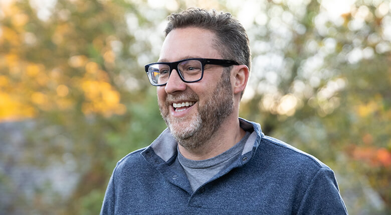 A closeup of John Miller smiling