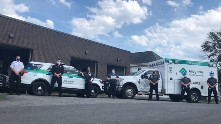 AHN Canonsburg EMS team stands in front of an ambulance