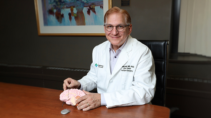 Dr. Whiting demostrating placement of electrodes on a brain model