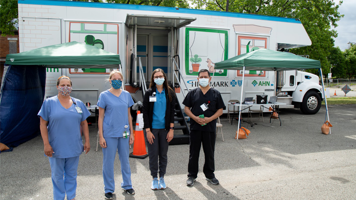 AHN caregivers stand outside testing vehicle